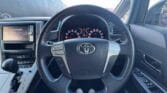 steering wheel view of white 2012 Toyota Vellfire