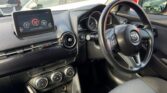 steering wheel and front seat view of 2014 Mazda Demio