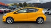 side view of luxury yellow 2014 Toyota Aqua S