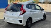 back side view of white luxury 2014 Honda Fit