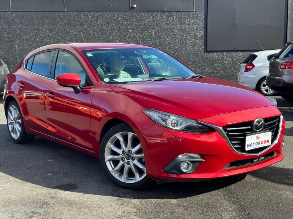 side view of red 2014 Mazda Axela