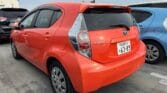 orange 2012 Toyota Aqua back side view