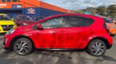 full side view of red 2016 Toyota Aqua