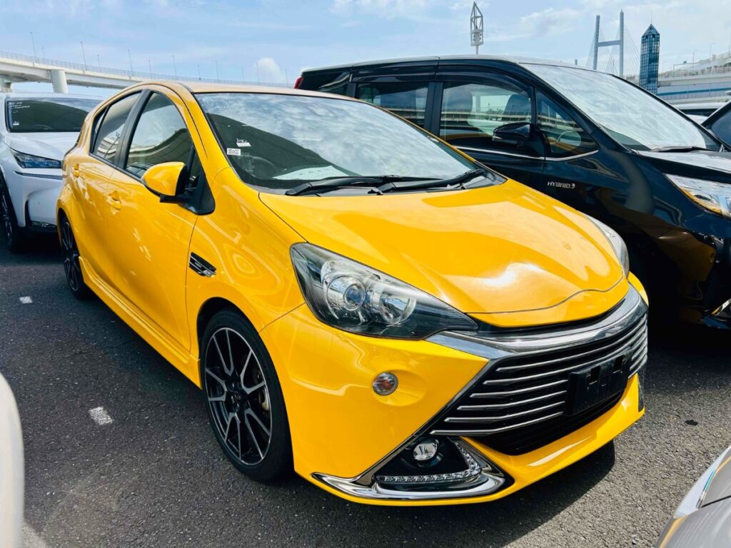 front side view of yellow 2016 Toyota Aqua