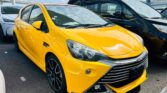 front side view of yellow 2016 Toyota Aqua