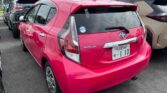 back side view of pink 2016 Toyota Aqua