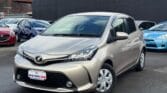 front side view of golden 2015 Toyota Vitz