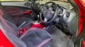 front seats view of red 2014 Nissan Juke