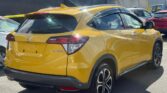 back side view of yellow 2018 Honda Vezel