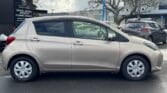 full side view of golden 2015 Toyota Vitz