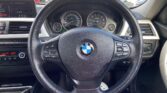 steering wheel view of 2014 BMW 320i