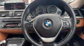 steering wheel view of 2014 BMW 320i I GRANTURISMO