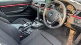 front door open view of 2014 BMW 320i