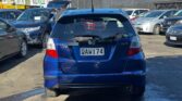 back view of blue 2010 Honda Fit